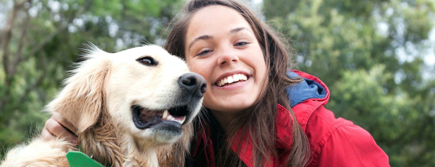 Girl petting the dog Girl petting the dog in the meadow